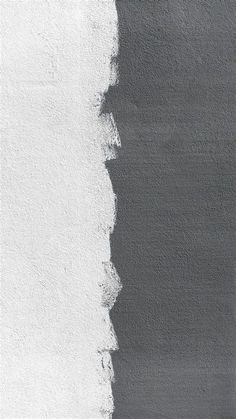 a black and white photo of a wall with paint chippings on it's side