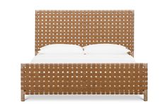 the headboard and foot board of a bed with white pillows on top of it