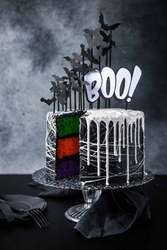 a cake decorated with white icing and sprinkles on a black table