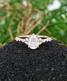 an engagement ring sitting on top of a rock