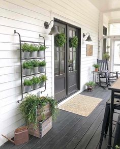 a porch with potted plants and chairs on it