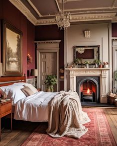 a bedroom with a bed, fireplace and painting on the wall