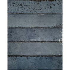 an image of wood planks painted in blue and grey colors with white paint on them