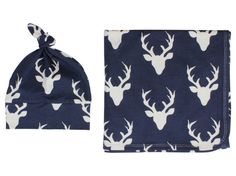 a baby's hat and blanket set with deer heads on it, both in navy blue