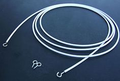 a white cord with two hooks on it