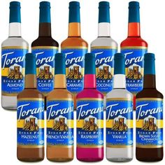 six bottles of torani syrup are lined up