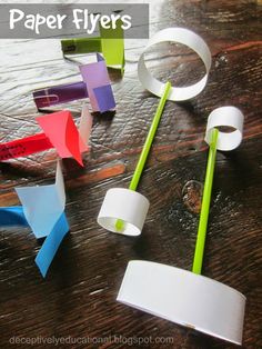 paper flyers on a table with scissors and other crafting supplies in the foreground