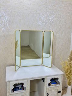 a white desk with two drawers and a mirror on top