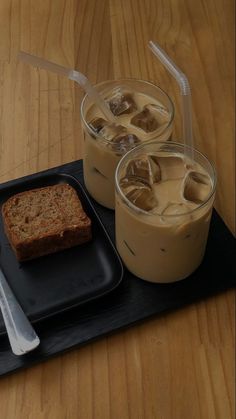 two glasses of iced coffee with slices of bread on a tray