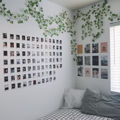 an unmade bed in a bedroom with pictures on the wall