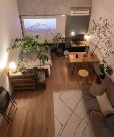 a living room filled with furniture and a flat screen tv mounted to the side of a wall