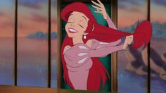 ariel from the little mermaid with her hair flying in the air and looking at something