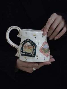 a woman holding a coffee mug with pictures on the outside and inside it's handle