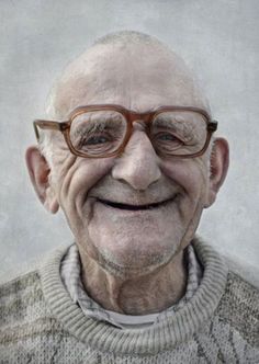 an old man with glasses smiling for the camera