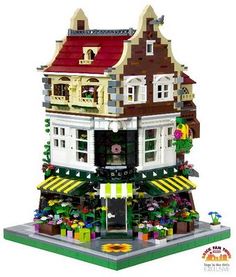 a lego house is shown with flowers and plants on the front porch, and an awning