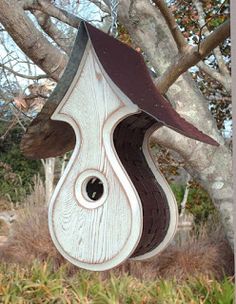 a bird house hanging from a tree branch