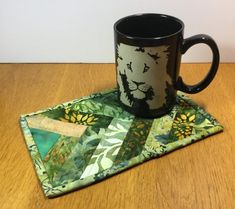 a coffee cup sitting on top of a coaster