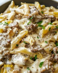 a close up of a plate of pasta with meat and cheese on it, topped with parsley