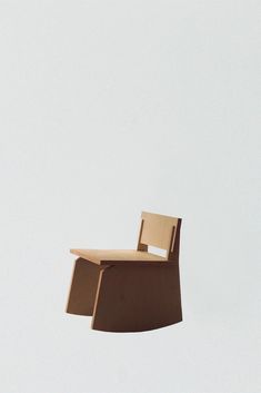 a wooden chair floating in the air with its back end extended and it's seat up