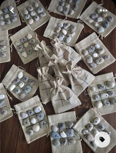 several small bags filled with rocks on top of a wooden table