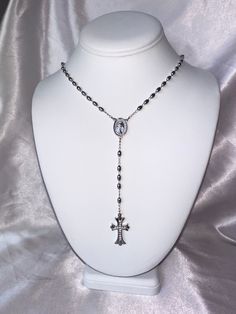 The Rosary Lariat is the perfect addition to any jewelry stack! This 24 inch lariet has a gothic inspired cubic zirconia cross. Choose from either silver (rhodium filled) or 18k gold (filled). No matter how you wear it, this necklace is sure to make a statement! Cross Necklace Long, Dark Jewellery Aesthetic, Gothic Rosary Necklace, Gothic Jewelry With Cross Pendant And Adjustable Chain, Gothic Jewelry With Adjustable Chain And Cross Pendant, Elegant Adjustable Crucifix Jewelry, Gothic Cross Jewelry With Adjustable Chain, Adjustable Gothic Cross Pendant Jewelry, Elegant Sterling Silver Rosary With Cross