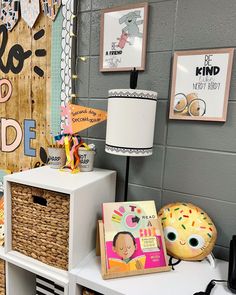 a room filled with lots of toys and books on top of a white table next to a wall