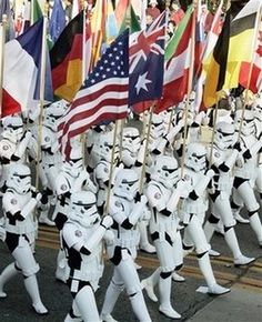 a group of stormtroopers marching down the street with flags in their hands,