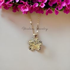 This pendant features a beautiful large Hibiscus flower with cubic zirconia stones. Absolutely stunning and sparkles in the light. The chain measures 21 inches with a 3 inch extender attached for your adjustment. You can easily adjust the necklace to your fitting up to 24 inches in length. The Gold chains are solid and sturdy and very durable. Hibiscus Pendant Measurements: Width: 25mm wide Height: 27mm Luxury Gold Flower Necklace, Luxury Delicate Jewelry With Flower Pendant, Hibiscus Flower Necklace, Hibiscus Jewelry, Gold Flower Jewelry, Hibiscus Necklace, Custom Gold Jewelry, Xoxo Jewelry, Crystal Jewelry Necklaces