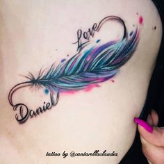 a woman's stomach with a tattoo that says love and a feather on it