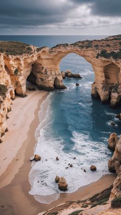 an arch shaped rock formation near the ocean