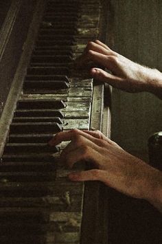 two hands are playing the piano together