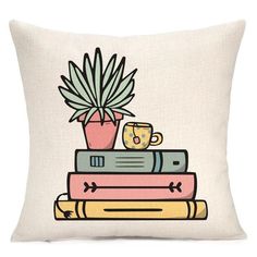 a stack of books with a potted plant sitting on top of it, and two mugs