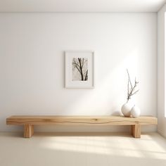 two white vases are sitting on a wooden bench in front of a framed photograph