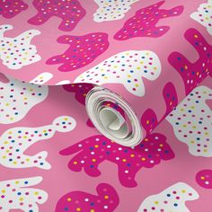 a pink and white wallpaper with polka dot design on the bottom half of it