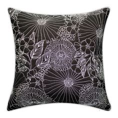 a black and white pillow with flowers on the front, in an intricate pattern design