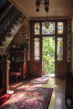 the sun shines through an open window into a room with wooden floors and stairs