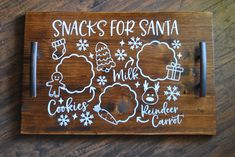 a wooden sign that says snacks for santa and other holiday related items on it's side