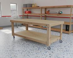 a workbench with shelves and tools on it in a room that is empty