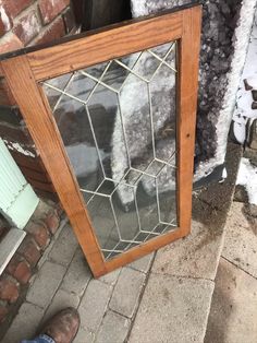 a person standing next to a wooden door with glass on the front and side windows