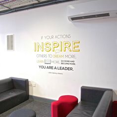 an office with couches and chairs in front of a wall that says if your actions inspire others to dream more, you are a leader