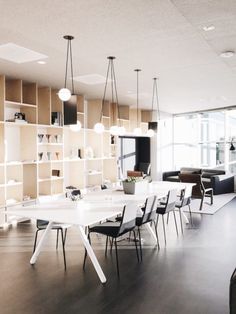 a large white table sitting in the middle of a room with lots of bookshelves