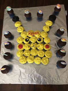 cupcakes are arranged in the shape of a face