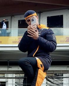 a man is taking a selfie with his cell phone in front of a building