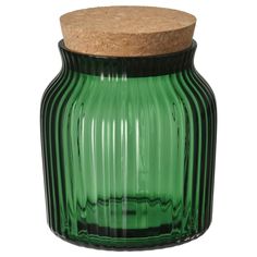 a green glass jar with a cork lid