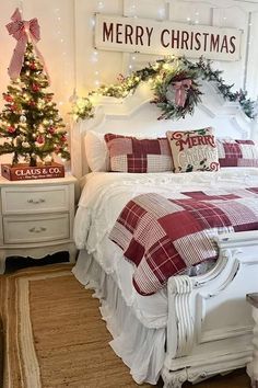 a bedroom decorated for christmas with red and white bedding, plaid comforter, lights and garlands on the headboard