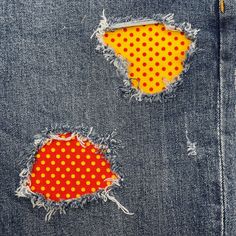 two pieces of torn denim with polka dots on them