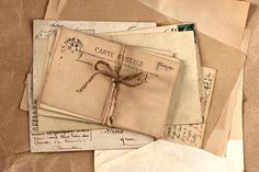 an old book with writing on it is tied up and sitting on top of some papers