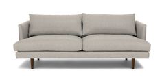 a gray couch sitting on top of a white floor