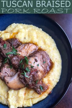 a blue plate topped with mashed potatoes covered in meat and garnished with parsley