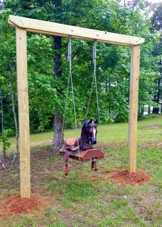 a wooden swing with a horse on it